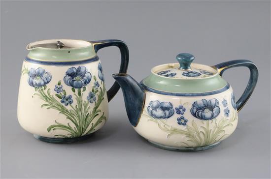 A Moorcroft Macintyre blue poppy teapot and matching milk jug, Rd. no. for 1905, teapot 20cm across